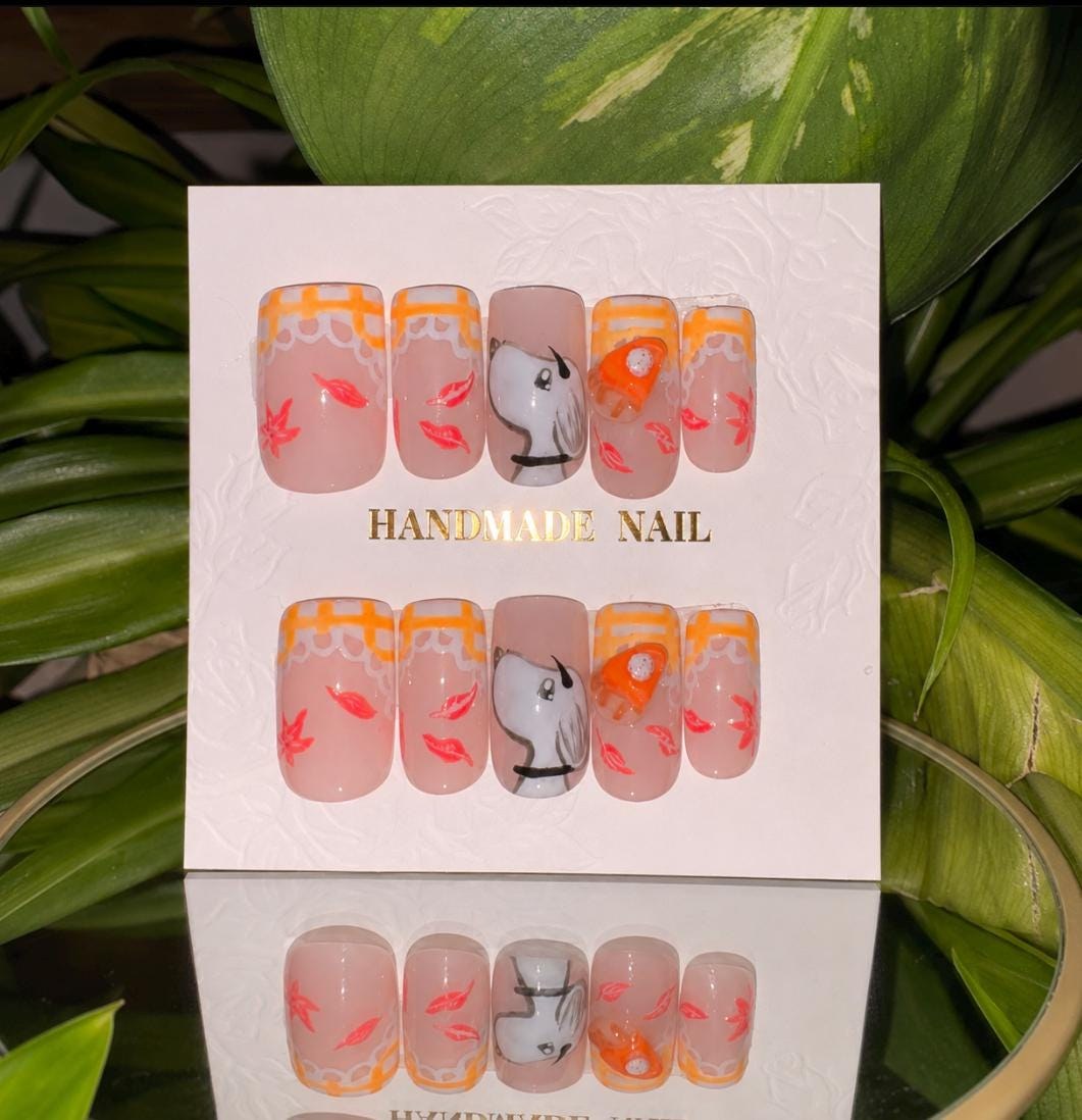 Autumn nail set with orange gingham tips, leaves, a white puppy and pumpkin details