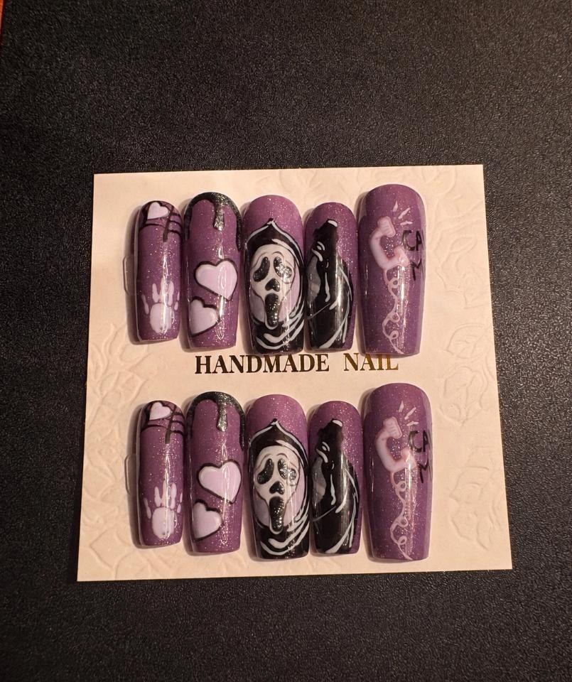 Purple glitter nail set with ghost mask art, hearts, spiderweb and telephone details
